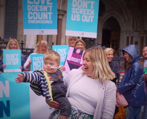 Maire and her toddler Aidan join the demonstration outside the court